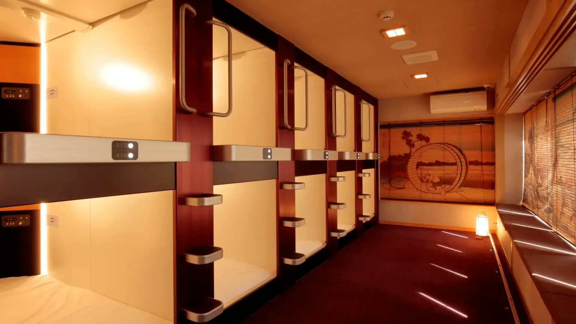 A row of fitted sleeping units along a shared passage